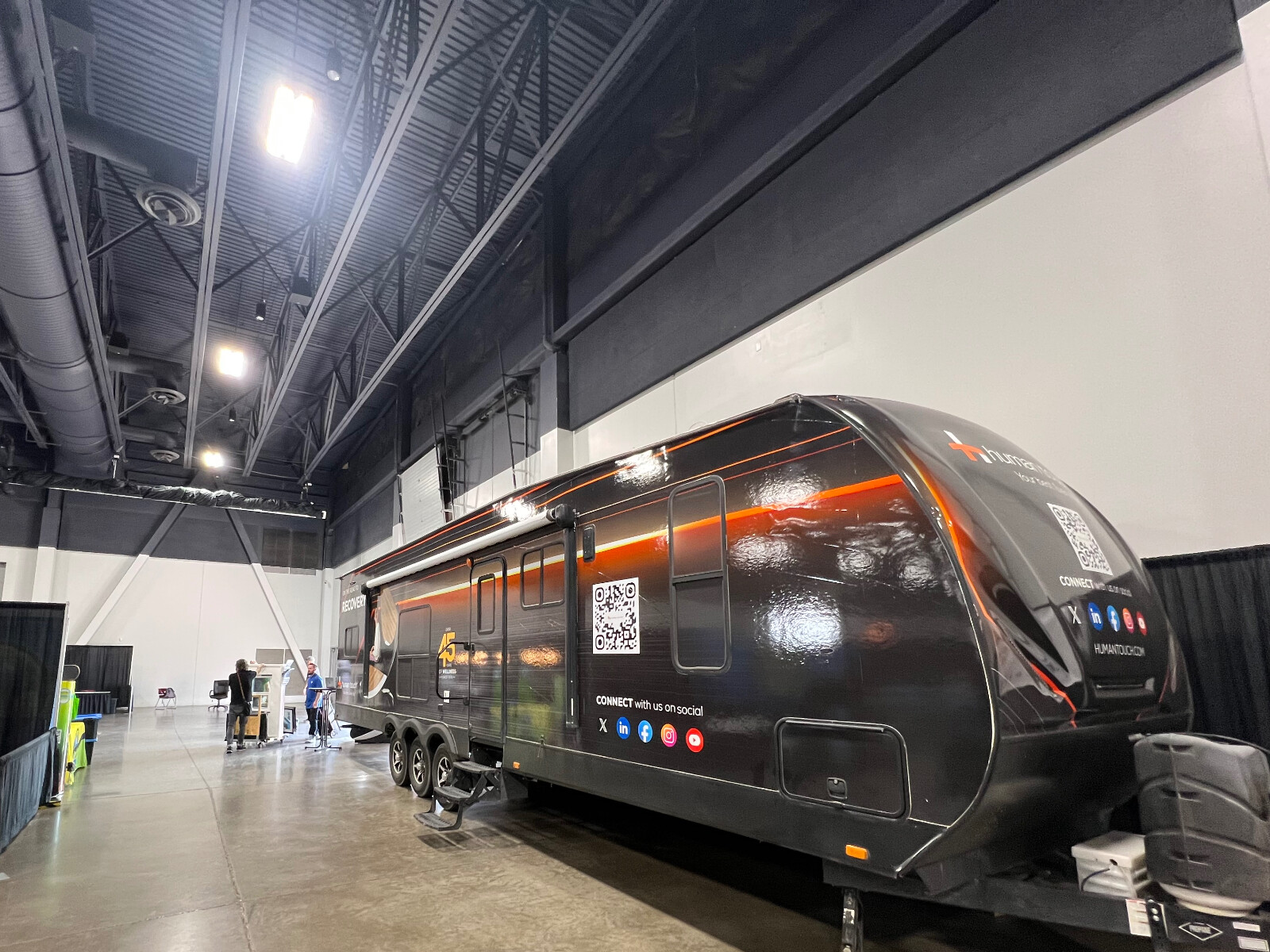 The Human Touch recovery RV inside an expo hall